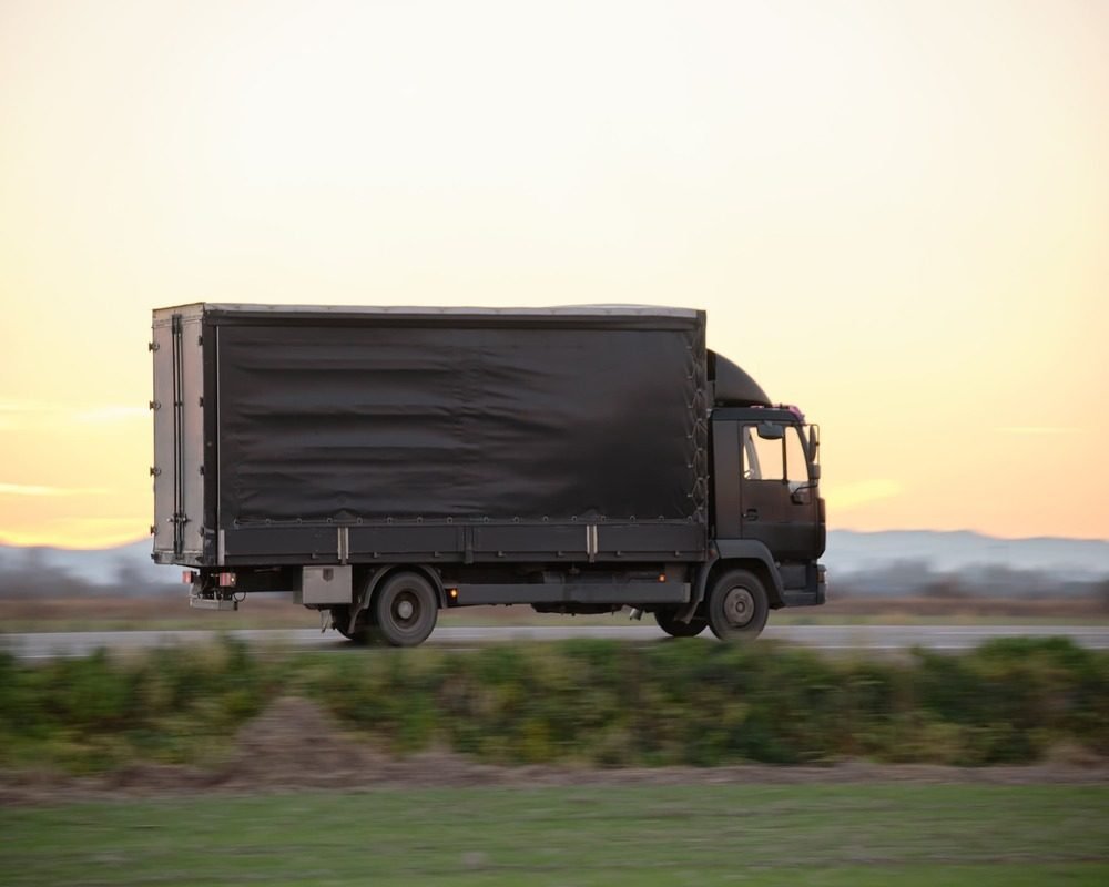 cargo-truck-driving-on-highway-hauling-goods-in-ev-2024-12-07-00-42-54-utc (1)